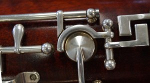 This is the Ab/Bb trill tone hole. It's surrounded by a mechanism that connects the thumb Ab key to the Ab tone hole on the front of the bassoon via a push rod.